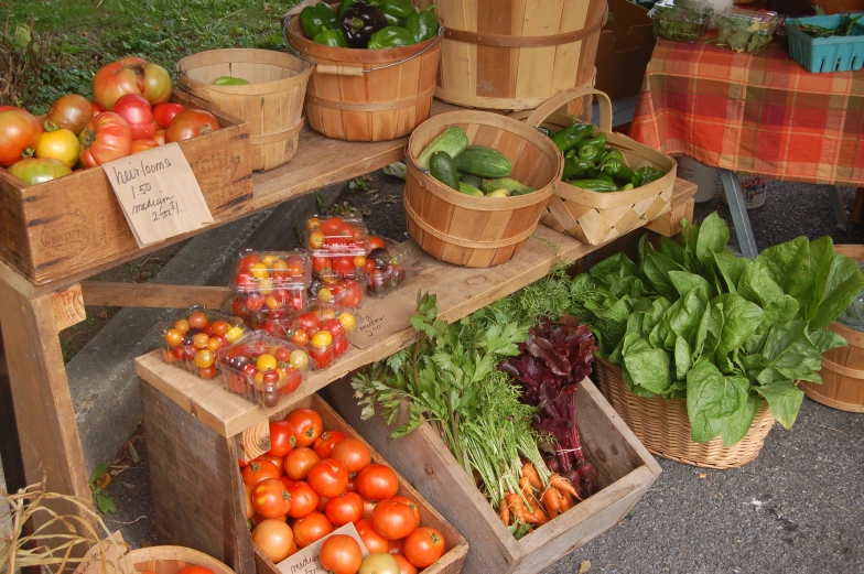 several wooden boxes filled with different kinds of fruits and vegetables