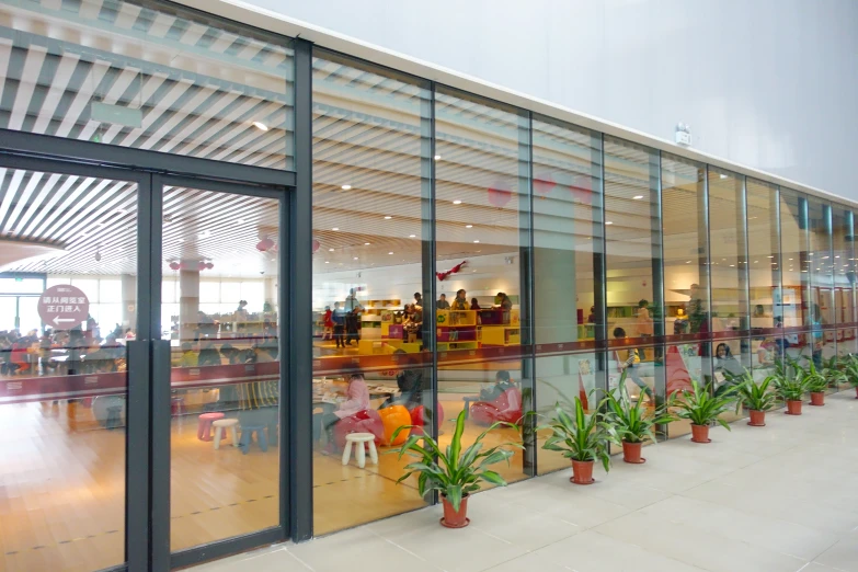 a very long room with people sitting at tables in it