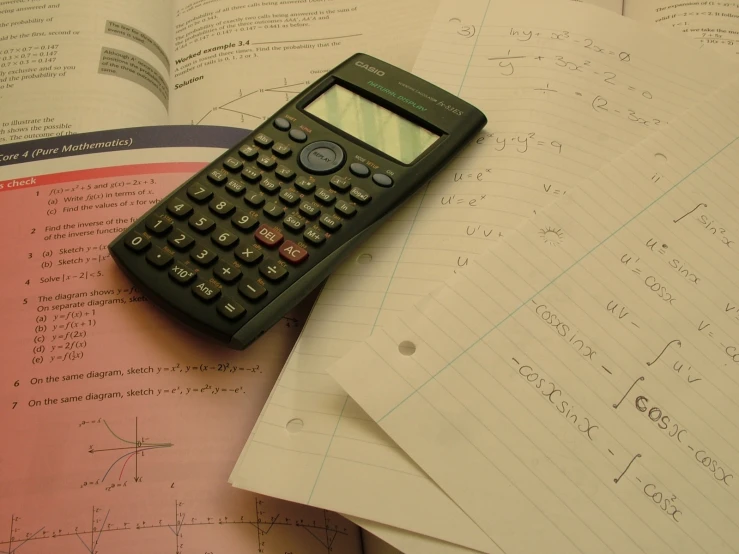 a calculator resting on an open book
