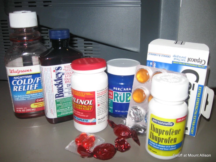 a counter with pills, tablets and medicine bottles