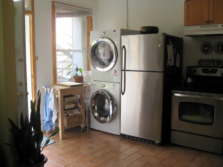 a white refrigerator and microwave combo with the inside of a washing machine