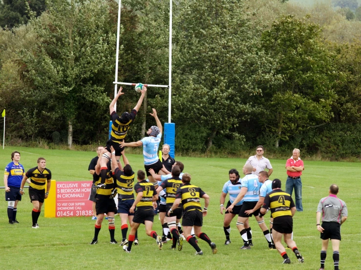 a group of men are playing football in a field