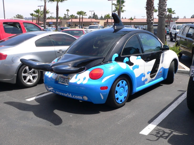 a blue and white car with some black on top