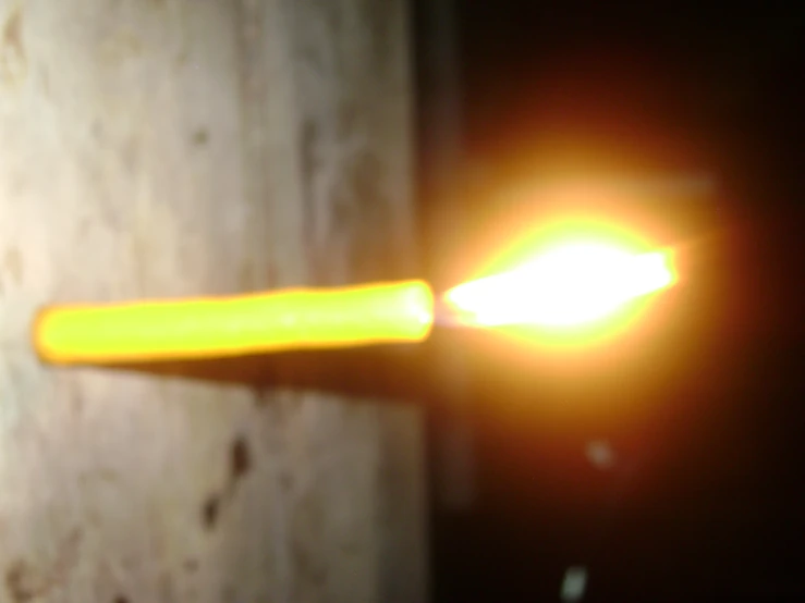 a blurry pograph of a light with a long yellow piece