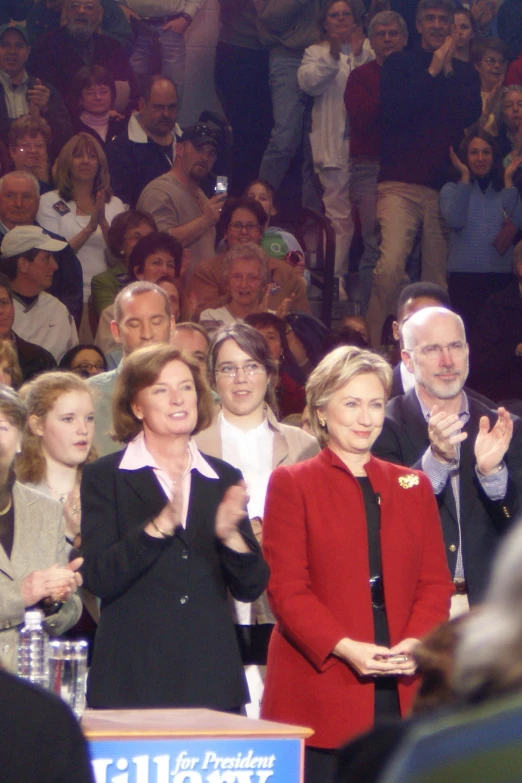 the woman is giving a speech to the crowd