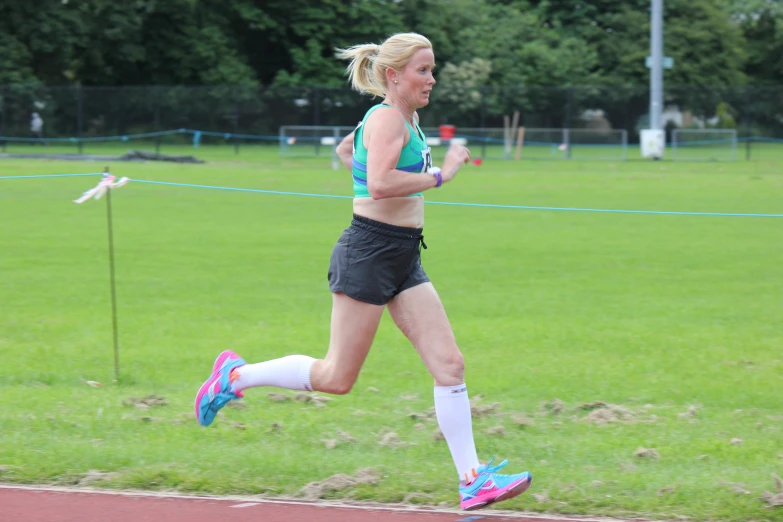 a female athlete running in a competition during the day