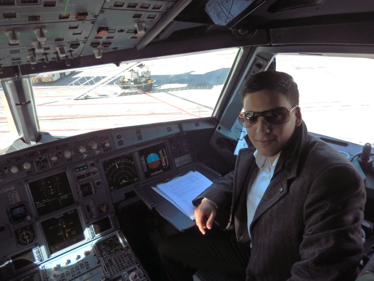 the pilot sits inside the airplane and displays the equipment