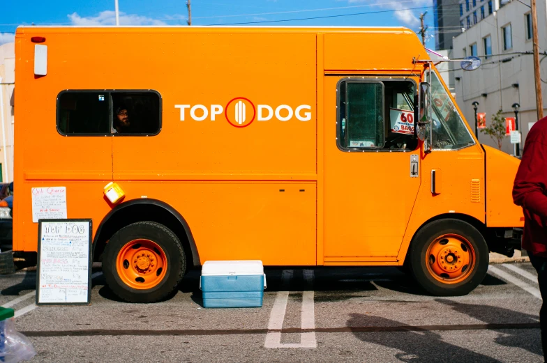 a yellow top 1 dog truck parked in a parking lot