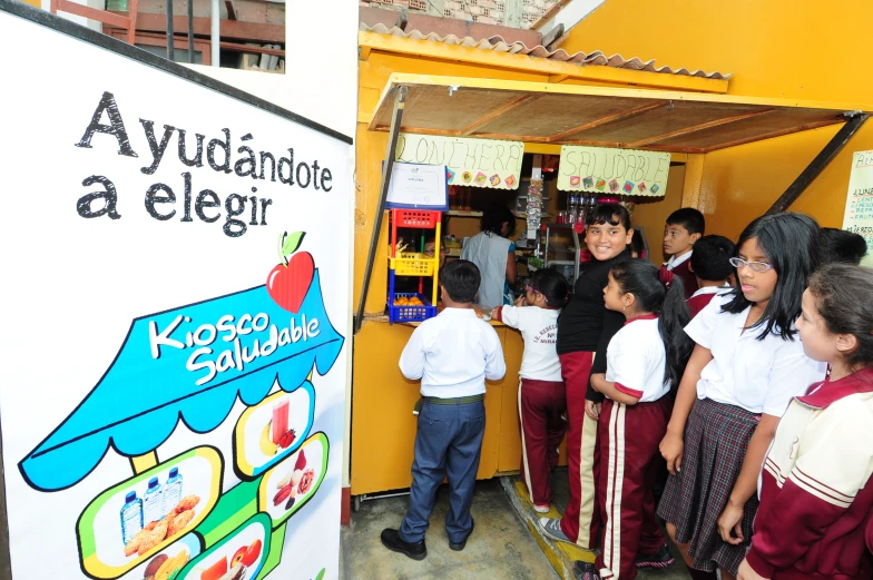 children and adults in uniform at an exhibit of sweets