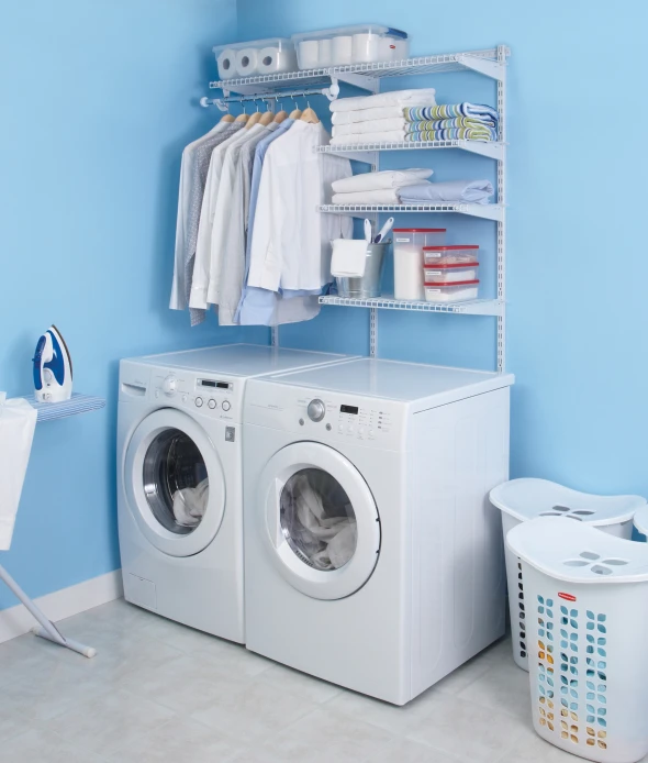 a laundry closet with the clothes on shelves and a washing machine