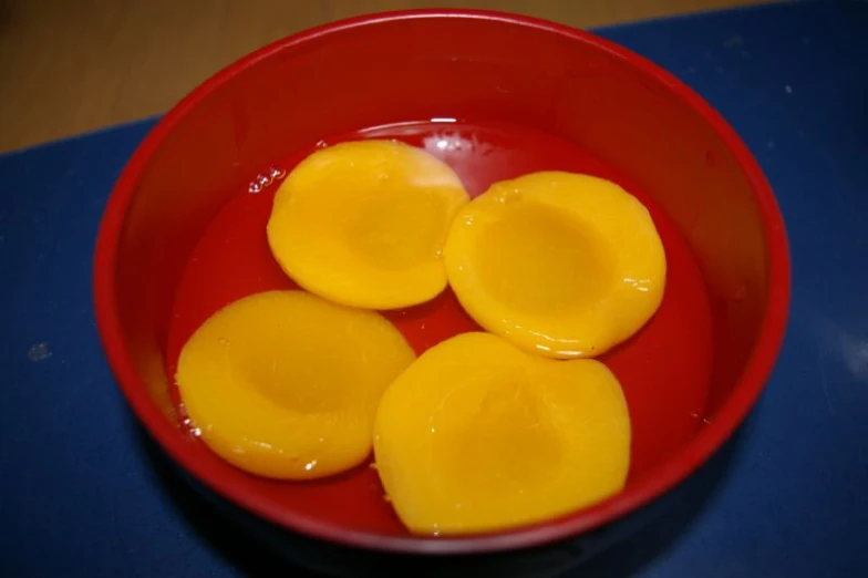 three sliced hard boiled eggs in a red bowl