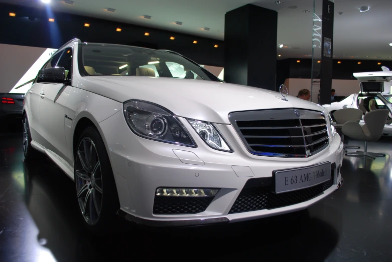 the front of a white mercedes s class with lights on