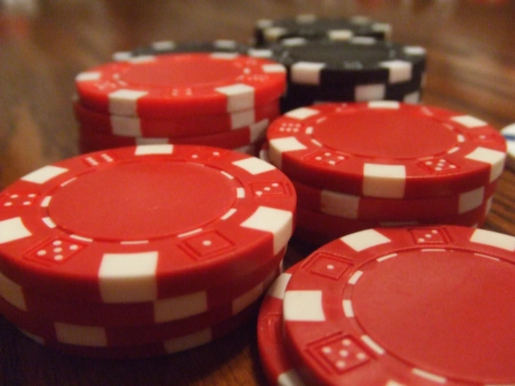 a closeup of several red and white poker chips