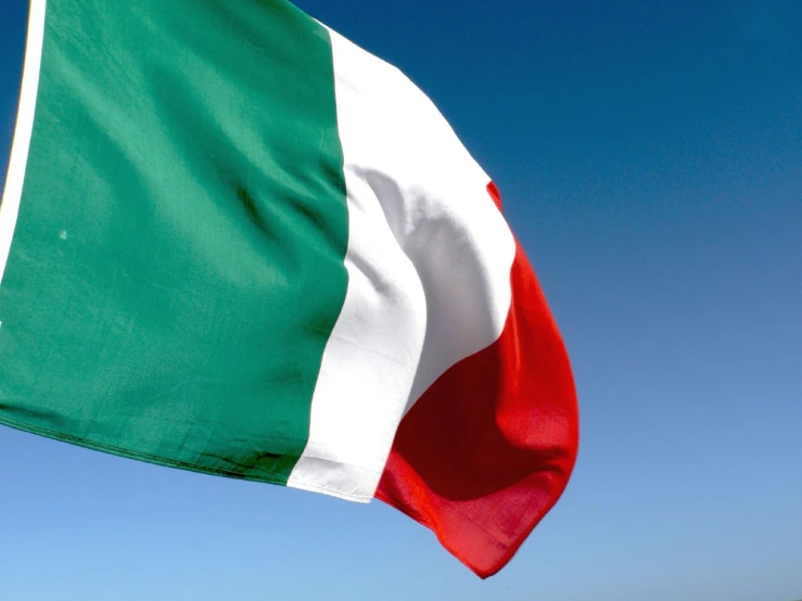 a large italian flag waving in the wind