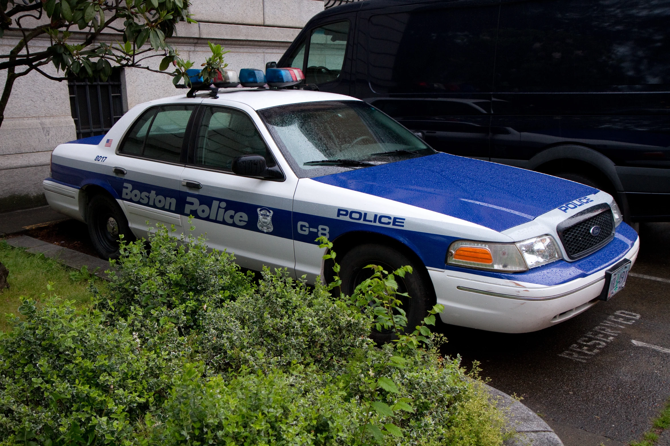 the police car is parked on the curb