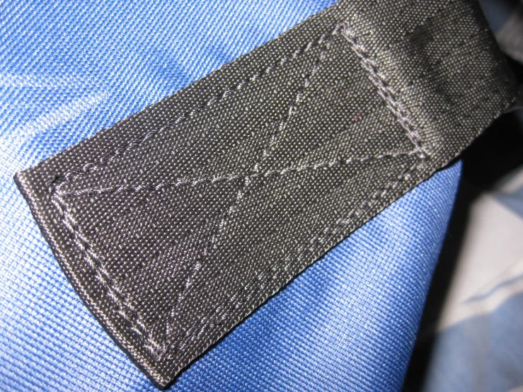 closeup of an old tie with a black patch