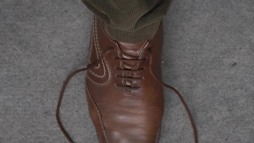 an image of a pair of boots with one tied to the heel