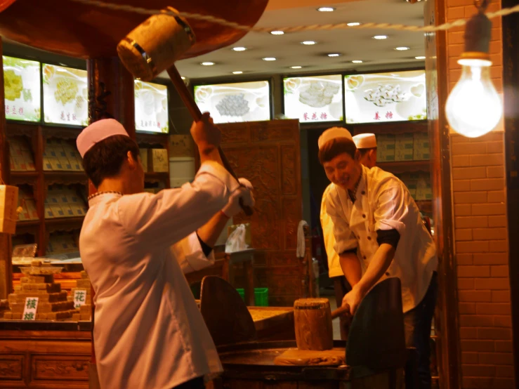 the two cooks are standing near a lamp