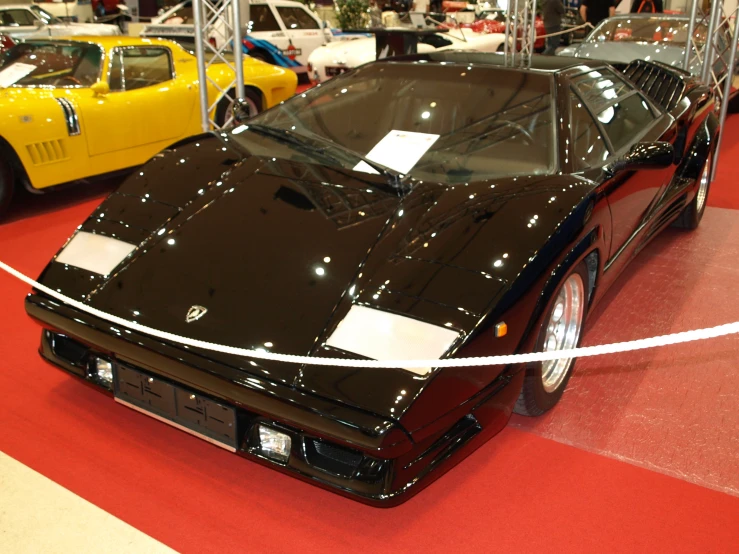 a group of cars are on display at a car show