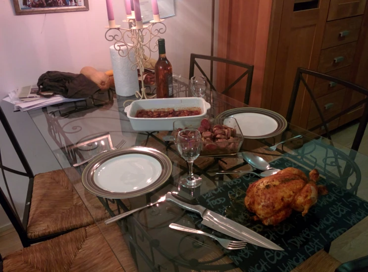 a dining room table has three place settings set for four, and silverware and two glasses are stacked on top of each other