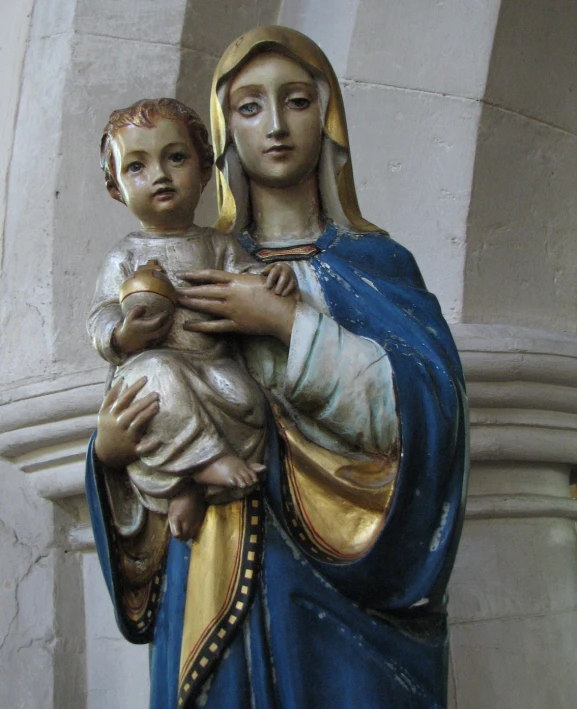 a statue of a mary holding a baby jesus