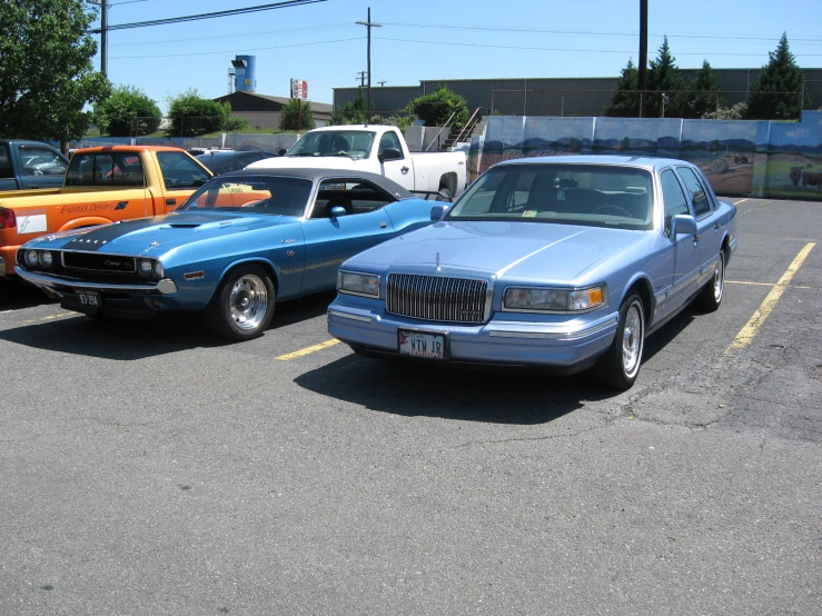 four cars are parked in a parking lot