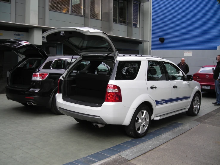 a small white car with open doors on it