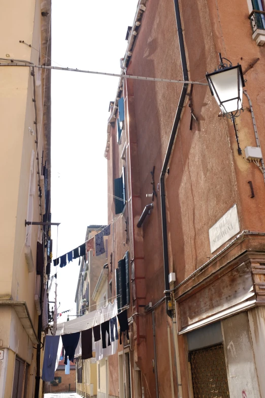 several clothes hanging on the wire outside a building