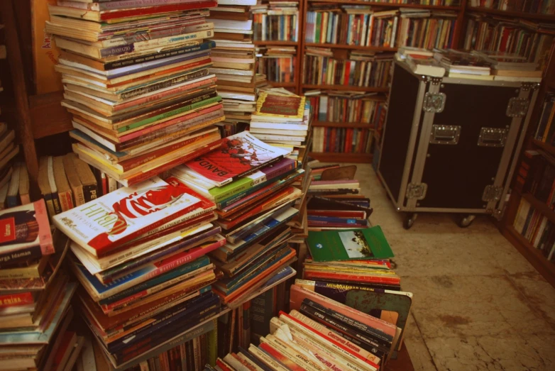a large amount of books sitting on top of a pile