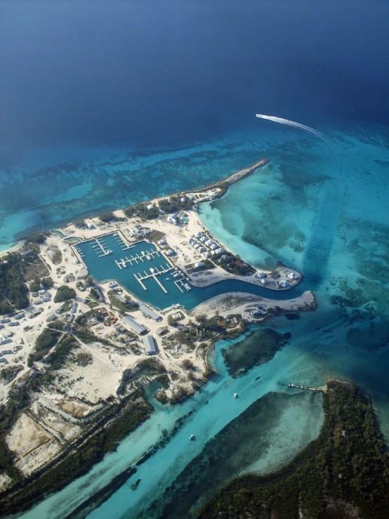 an aerial view of a large ship docked in the clear water