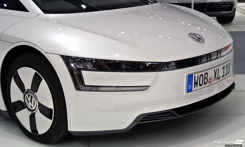 this white volkswagen volkswagon is on display in a showroom