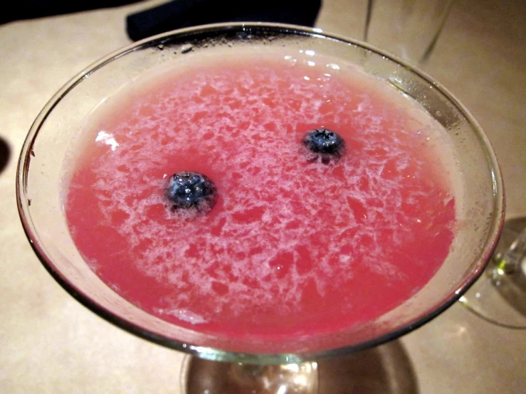 a martini glass with some berries on it