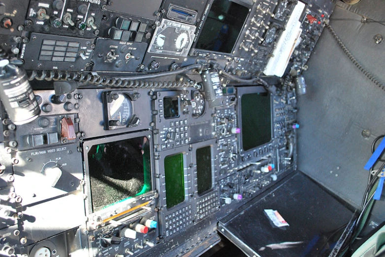 the interior of a jet fighter cockpit showing some monitors and various controls