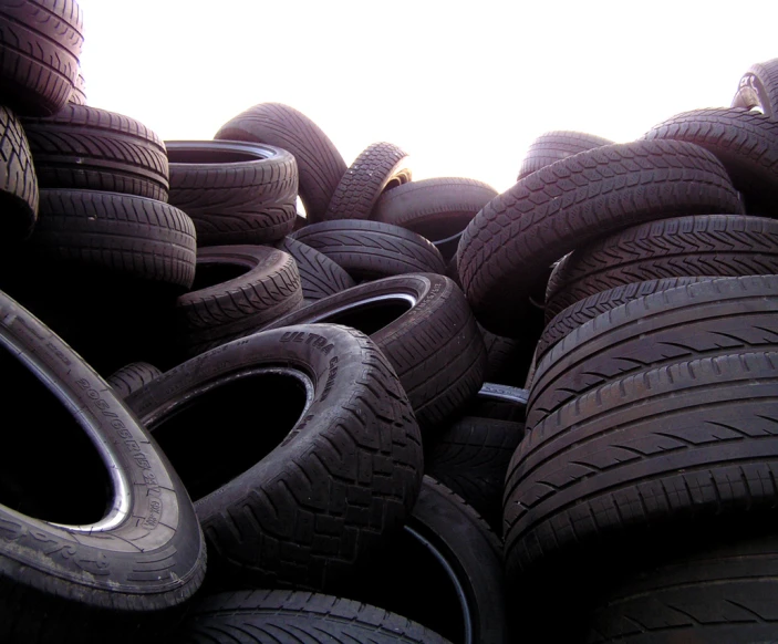 a pile of black, rubber tires stacked up