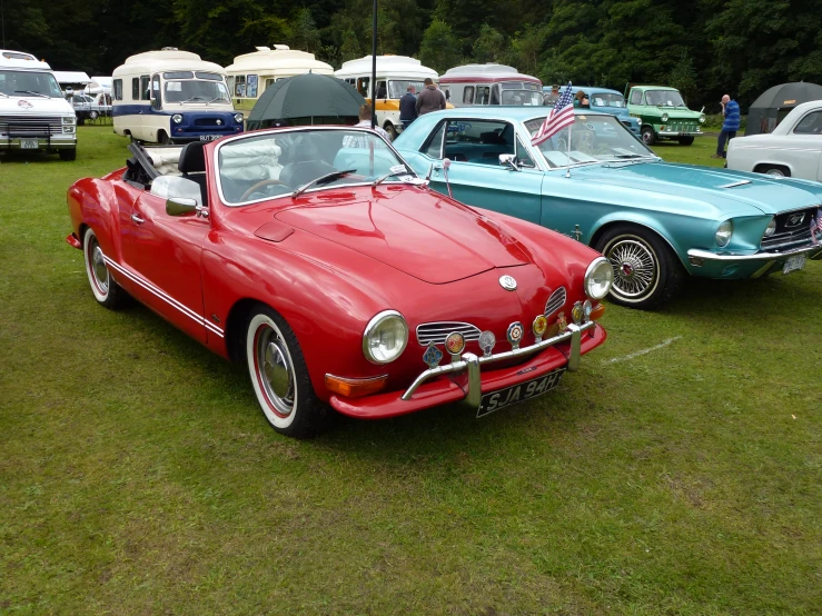 a group of three vintage cars parked next to each other