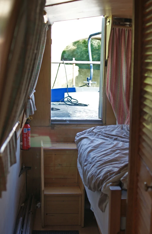 a room that has a bed with curtains on the other side