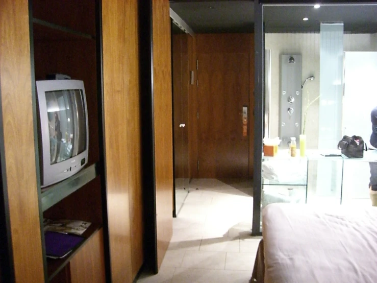 a room with a large glass window that is reflecting the television