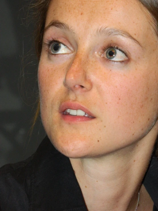 a close up image of a young woman wearing black