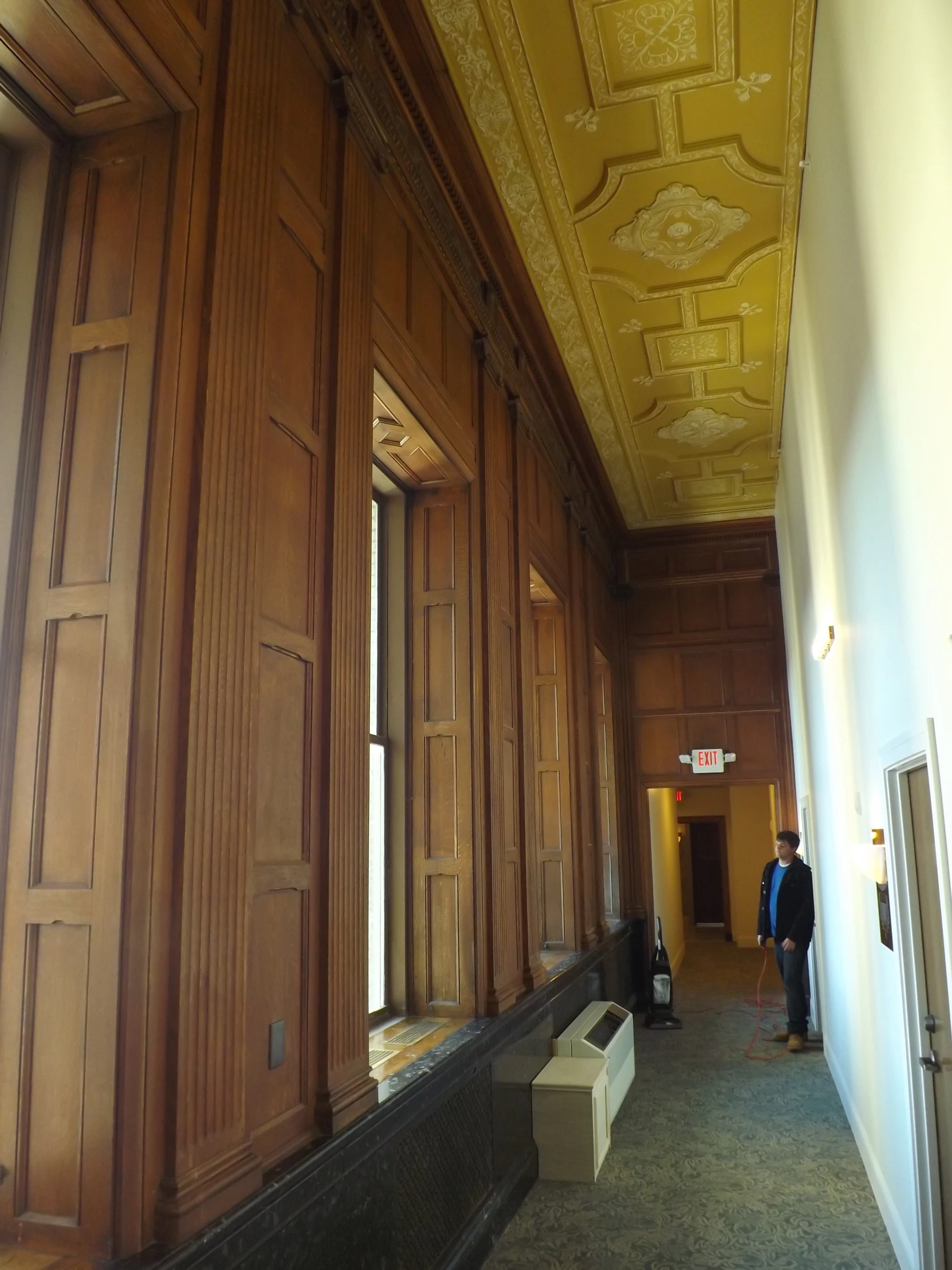 a hallway between two buildings with wooden doors