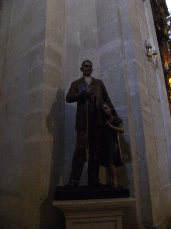 a statue is next to the building with a clock