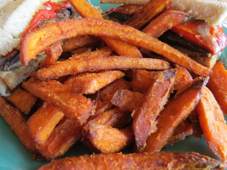 a plate with a pile of fries and a sandwich