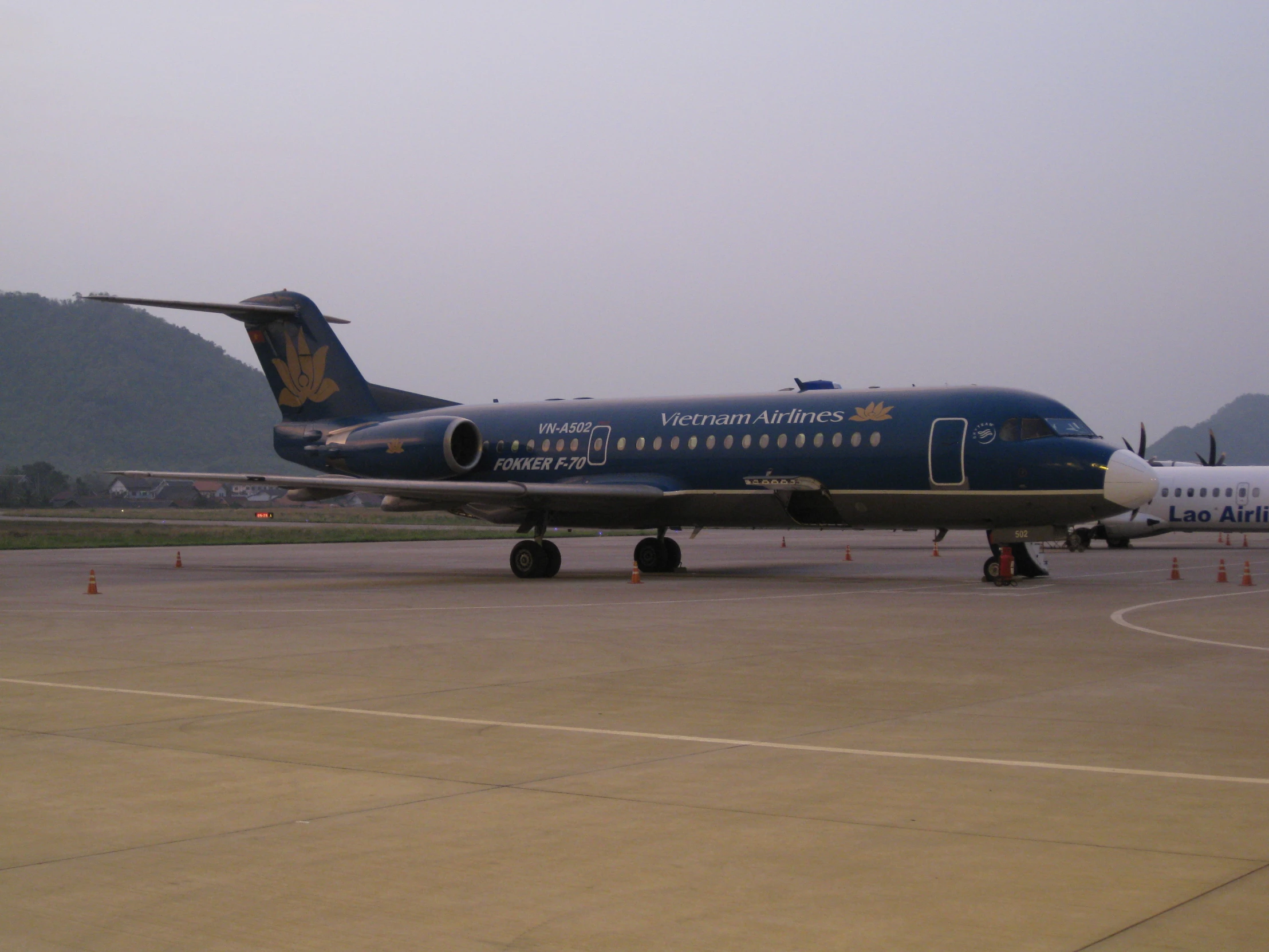 an airplane parked on the runway of a large airport