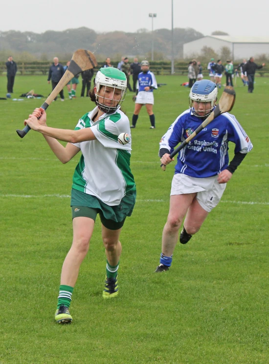 two female players playing a game on the field