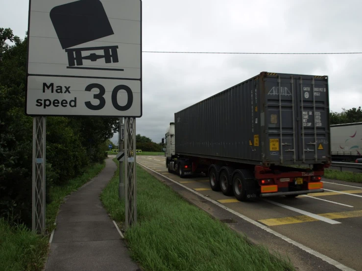 a truck and car are traveling side by side on a road