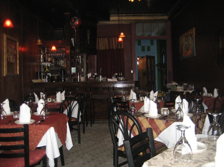 a restaurant with tables covered in white tablecloths