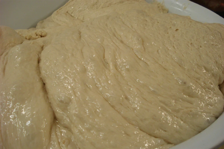 a large mixing bowl filled with batter on top of a table