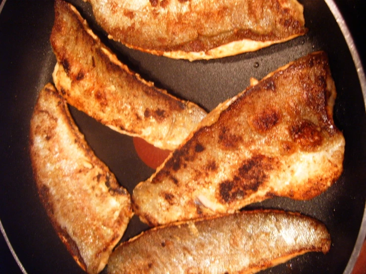 sliced bananas cooking in a pan on the stove