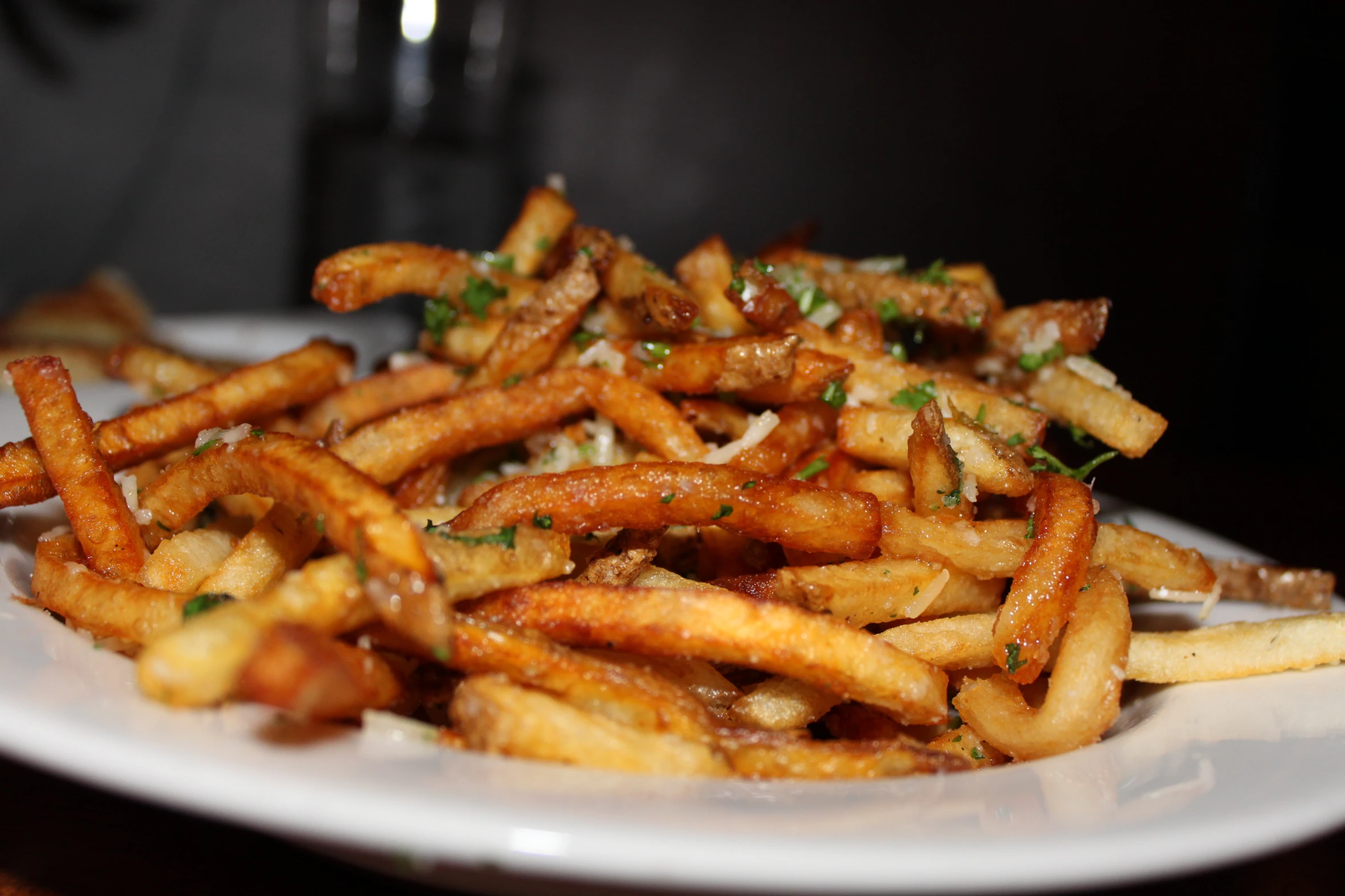 a plate of french fries on top of a table