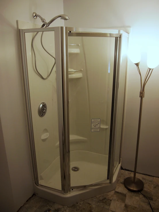 a shower with glass walls and two heads