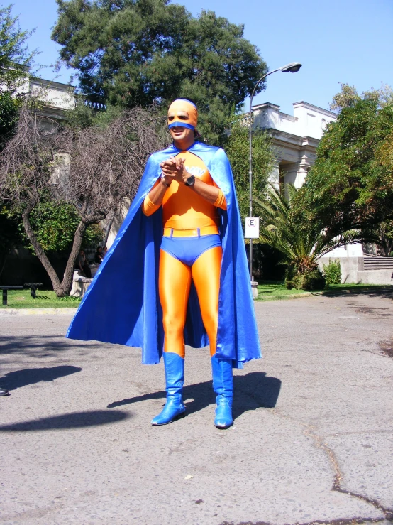 man dressed as an orange surfer in an outside setting